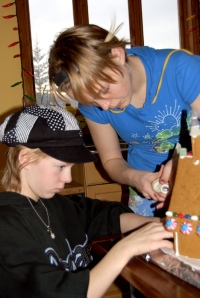 Megan and Allison building their gingerbread house